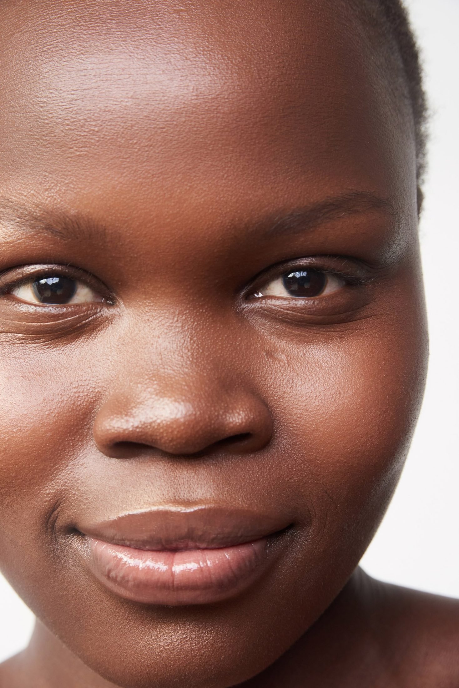 Close-up headshot of a smiling woman on a clean white background