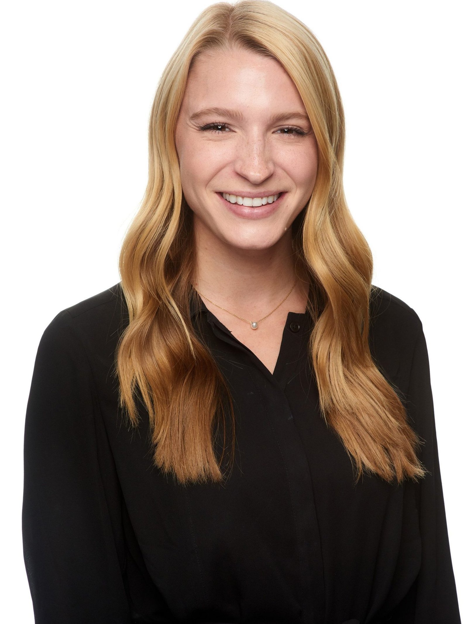 Business headshot of a smiling blonde woman in a black collared shirt